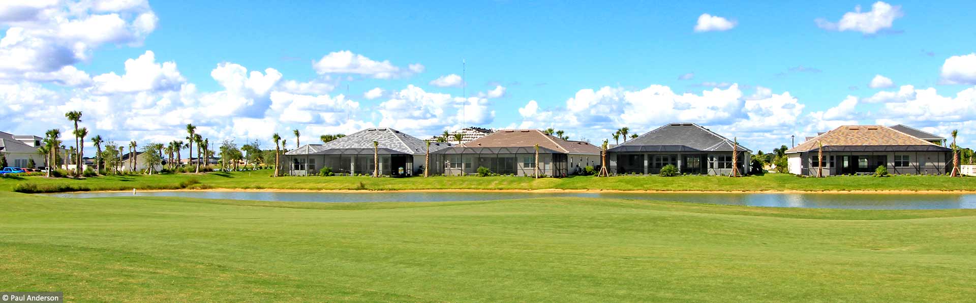 backside of homes overlooking water and golf course