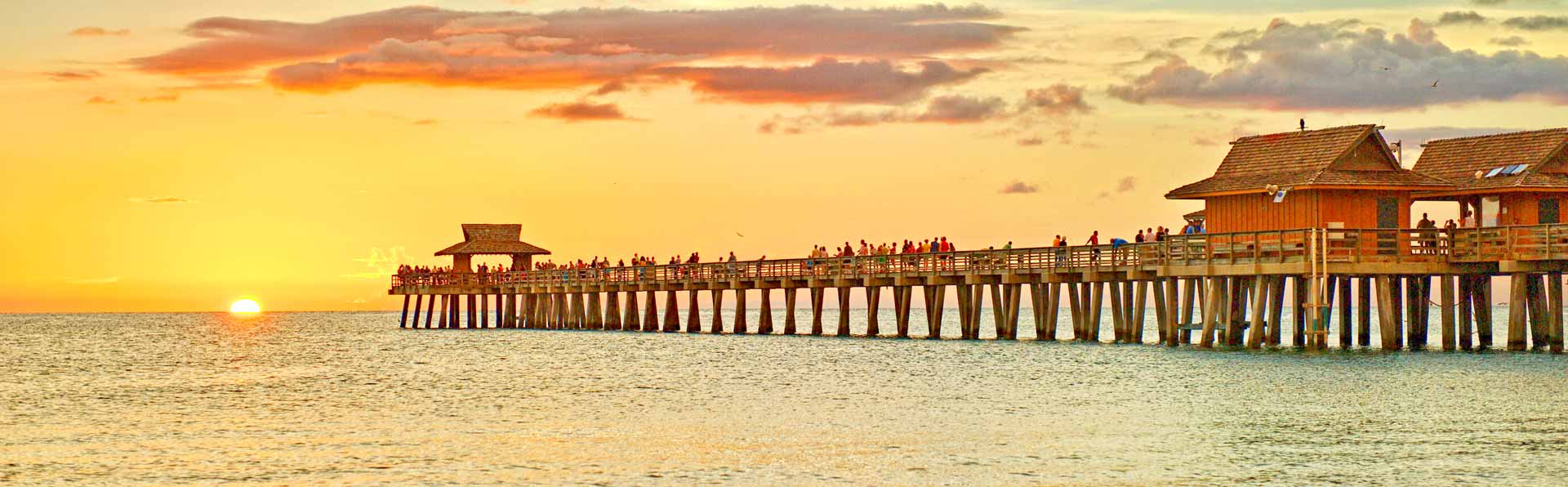 People watching sunset on the Naples Beach Pier