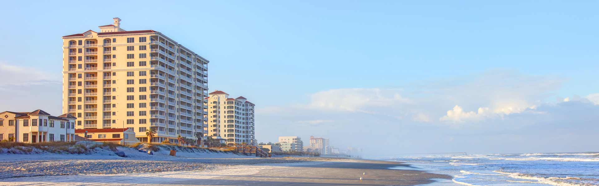 12 story condo building overlooking atlantic ocean and beach in early morning