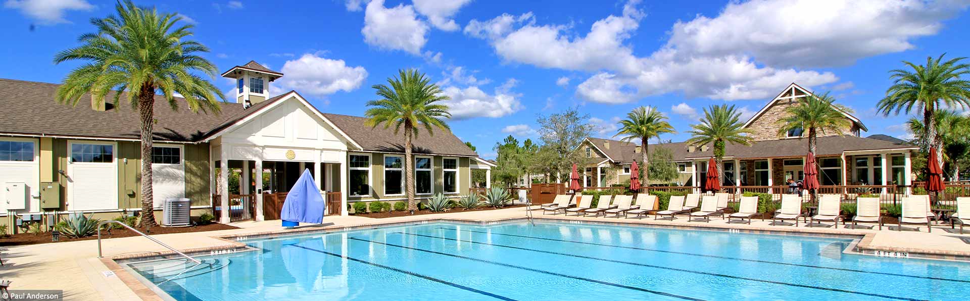 swimming pool and chairs by clubhouse