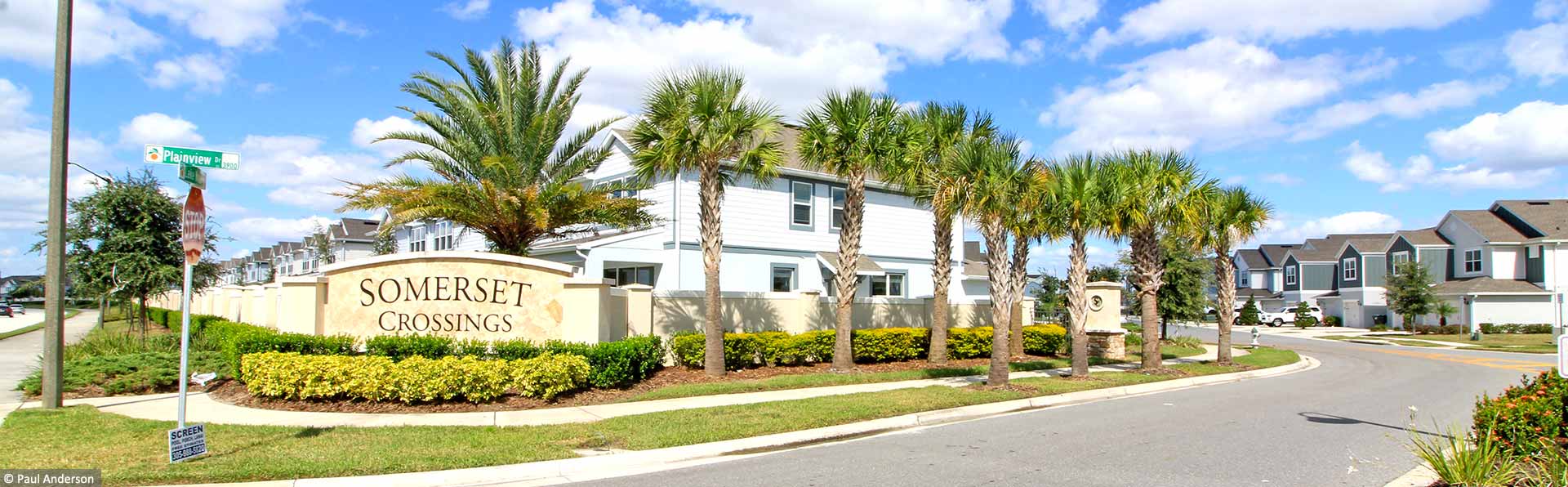 somerset community entrance with buildings and palm trees