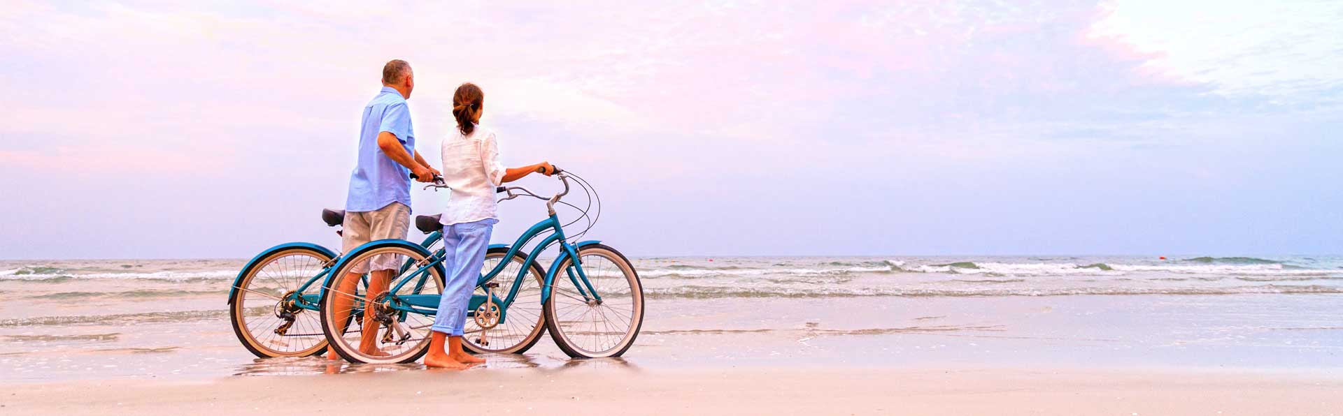 Seniors on bicycles on the beach