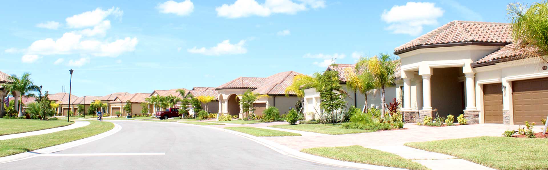 street view of new Florida homes with red tile roofs