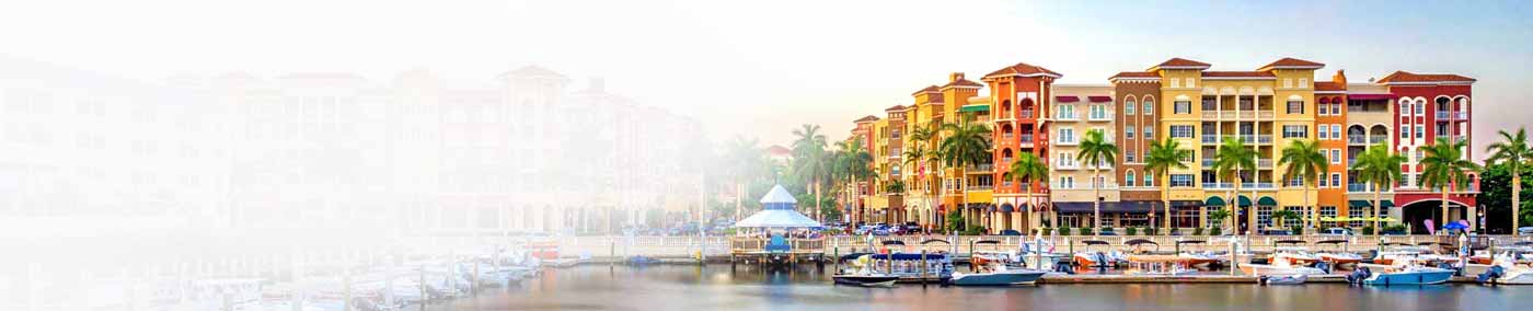colorful condo building overlooking marina with boats
