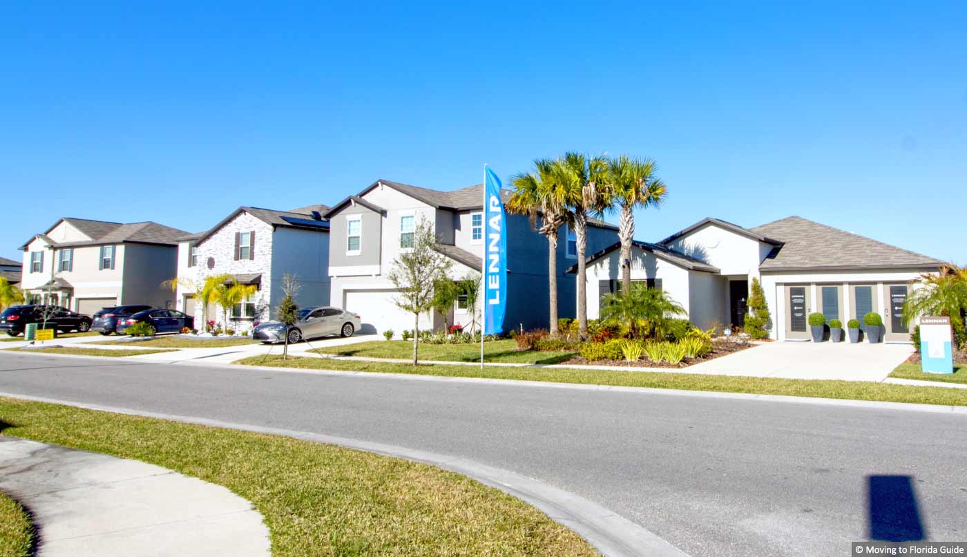 Two-story homes with blue sky and plam trees