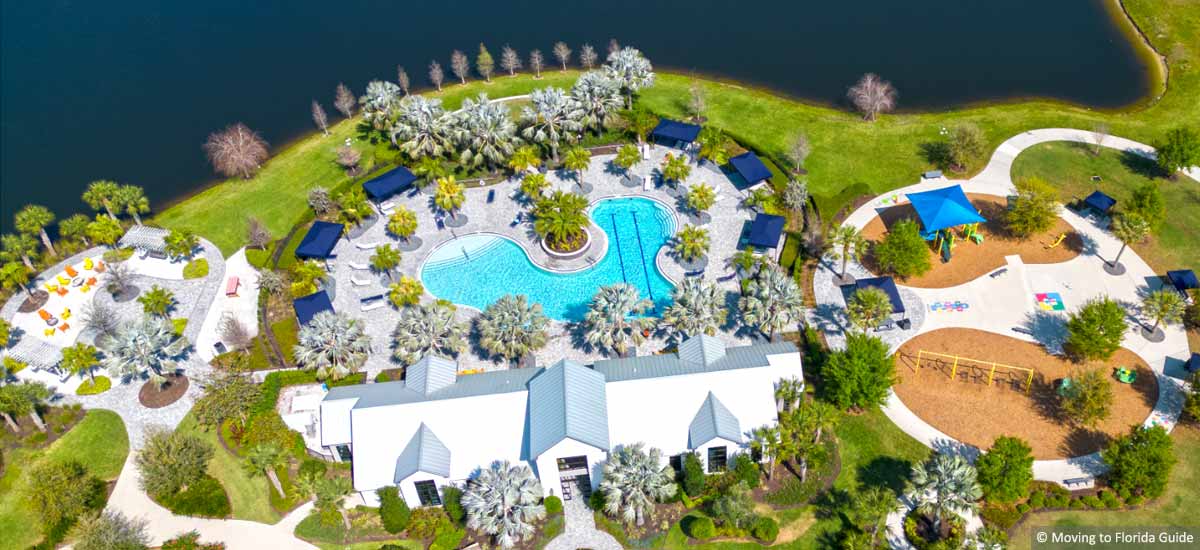 Aerial view of Florida clubhouse and pool next to lake
