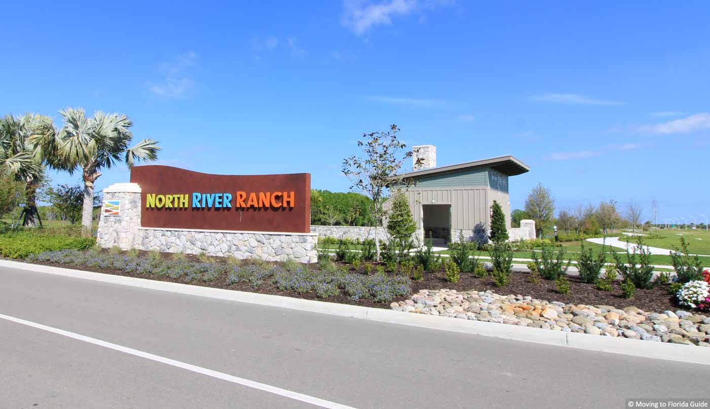 colorful housing community sign with tropical landscape