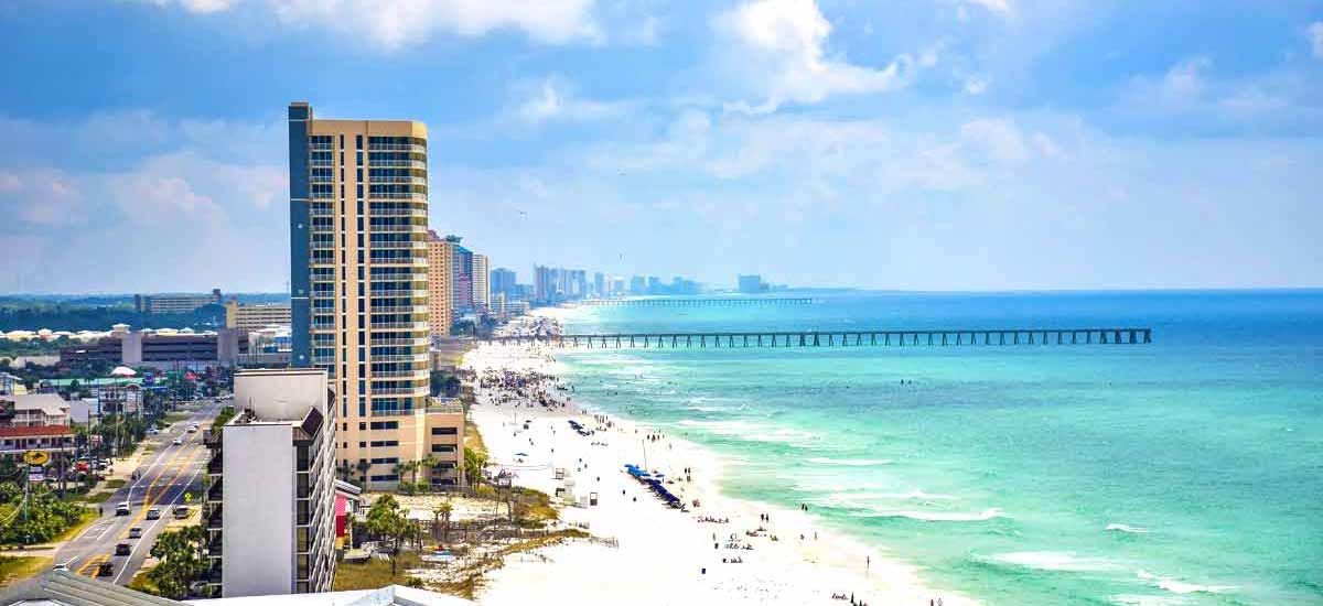 Tall condo buildings overlooking emerald hue gulf waters