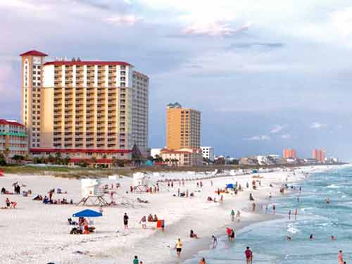 pensacola beach coastline with beachgoers and waterfront condos