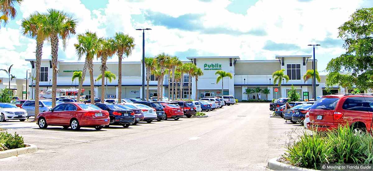 shopping plaxa with palm trees and cars in parking lot
