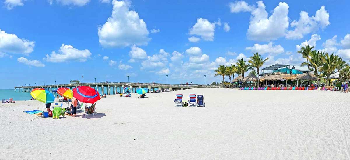 beachgoers with the venice pier and sharkys in the background