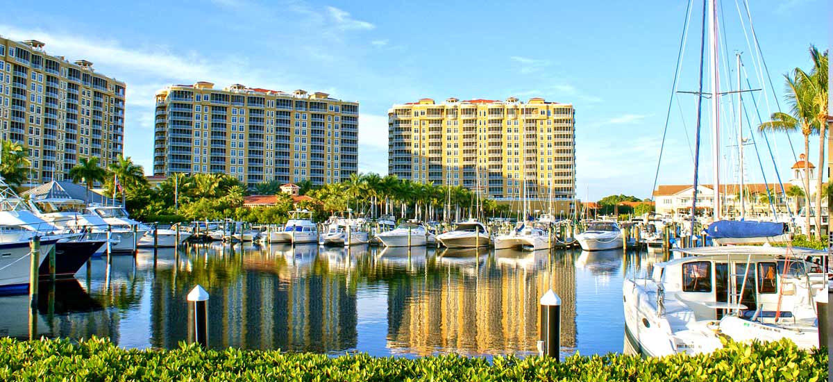 tall condo buildings overlooking boat marina