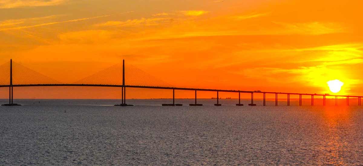 sunset view of the sunshine skyway bridge