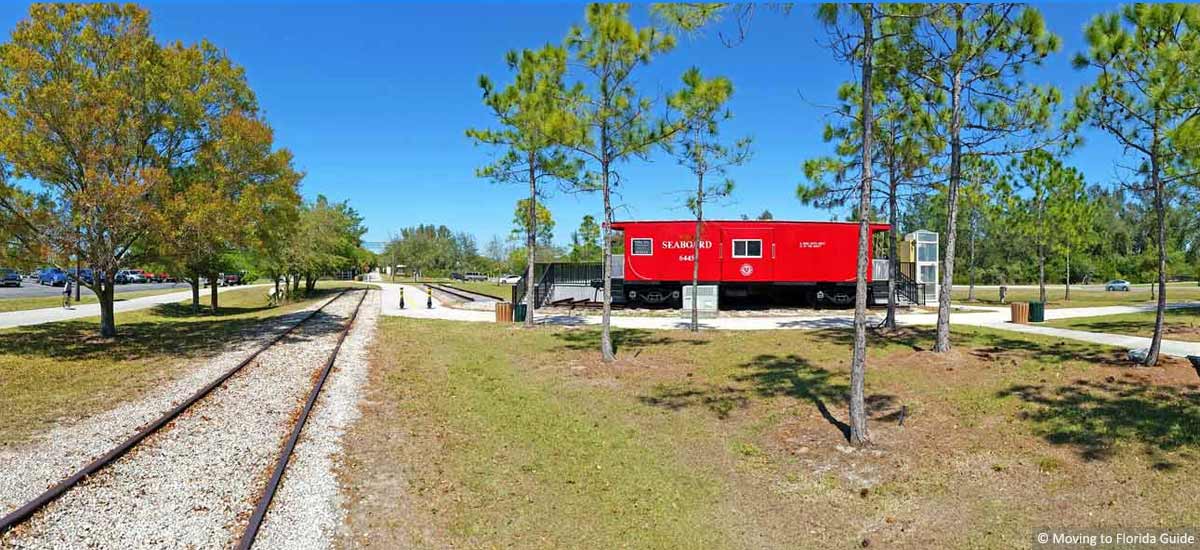 red caboose next to train track in a Florida Park